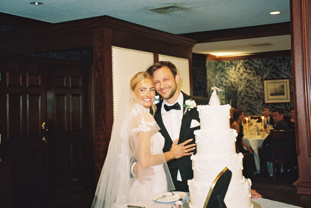 bride and groom by cake