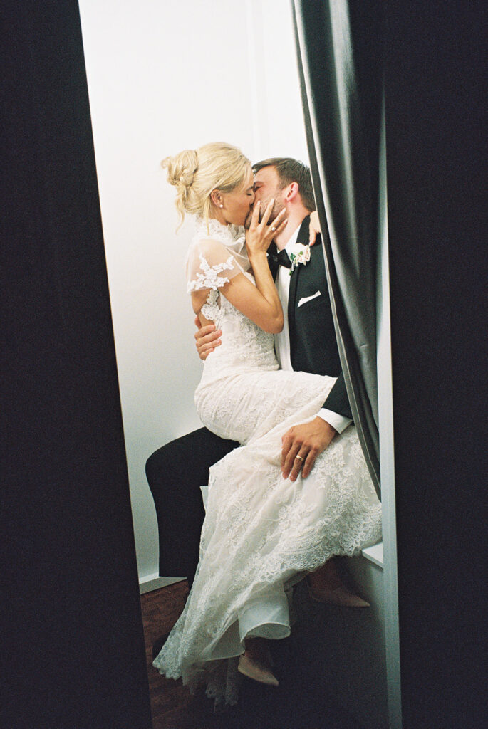 bride and groom kissing in Photo Booth