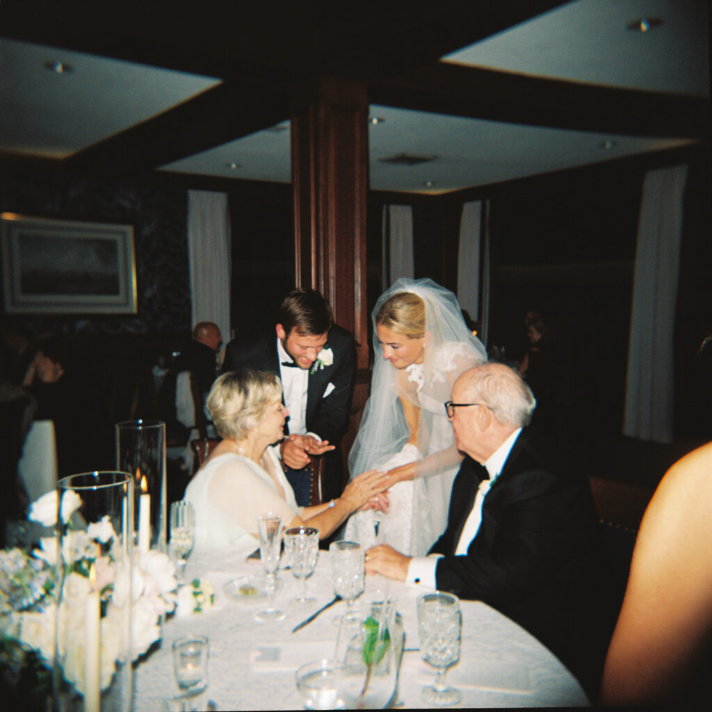 bride and groom talking to grandparents at wisconsin wedding