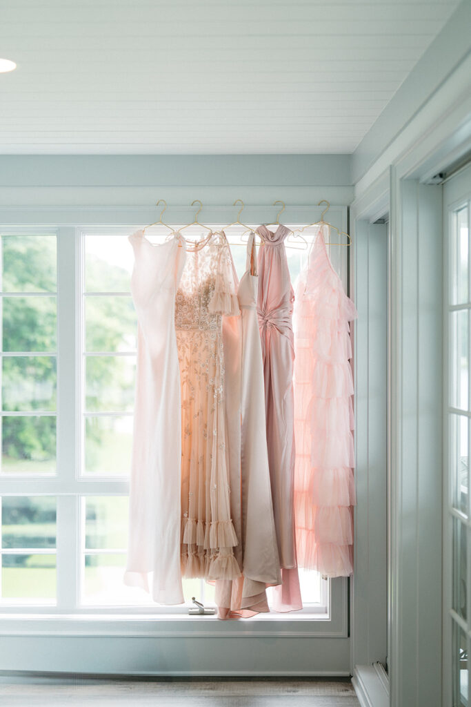bride and pink bridesmaids dresses hanging