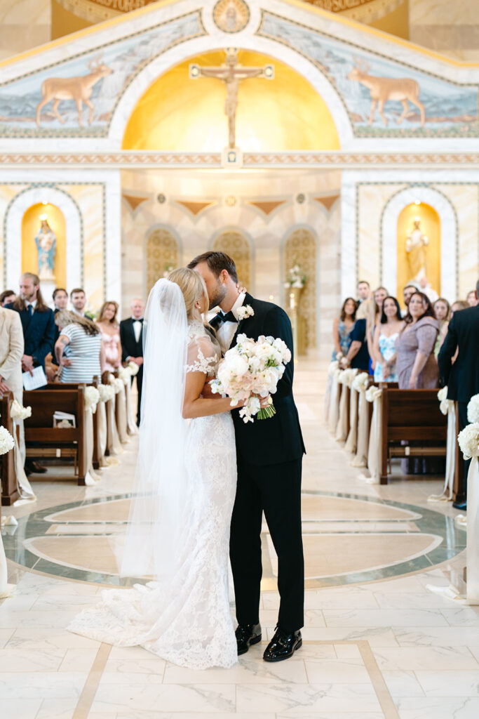 bride and groom kiss after ceremony