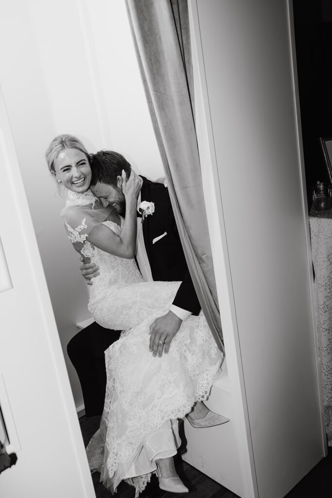 bride and groom giggling in Photo Booth
