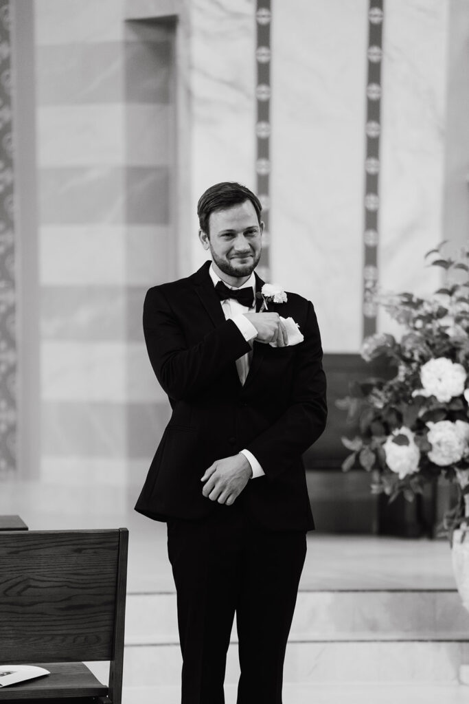 groom crying at the end of the aisle